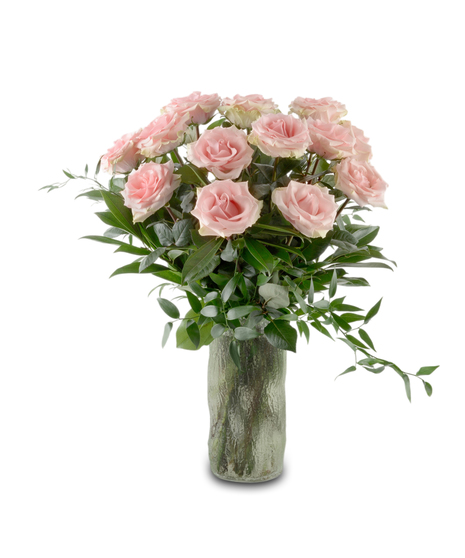 Blush pink roses arranged in a glass vase with greenery and optional baby's breath, forming a full romantic bouquet available in multiple rose counts.