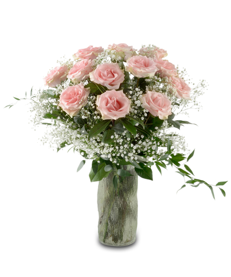 Blush pink roses arranged in a glass vase with greenery and optional baby's breath, forming a full romantic bouquet available in multiple rose counts.