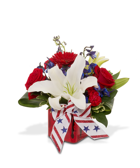 The American Dream bouquet: red roses, white lilies, blue delphiniums in a red mercury glass cube. Local Saint Louis delivery.