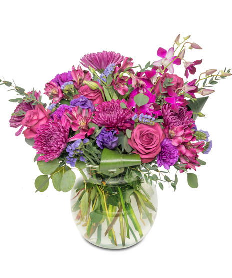 A lavish arrangement showcasing an array of oversized purple blooms, including roses, orchids, and alstroemeria, harmoniously combining shades of royalty and elegance