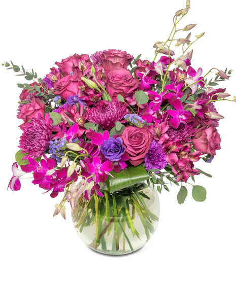 A lavish arrangement showcasing an array of oversized purple blooms, including roses, orchids, and alstroemeria, harmoniously combining shades of royalty and elegance