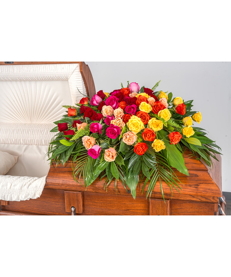 Vibrant all-rose casket spray in hot pink, red, yellow, peach, and orange, a heartfelt tribute.