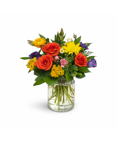 Seasonal mixed flower arrangement with three roses and fresh accent blooms in a 5-inch clear glass cylinder vase with lemon leaf greenery.