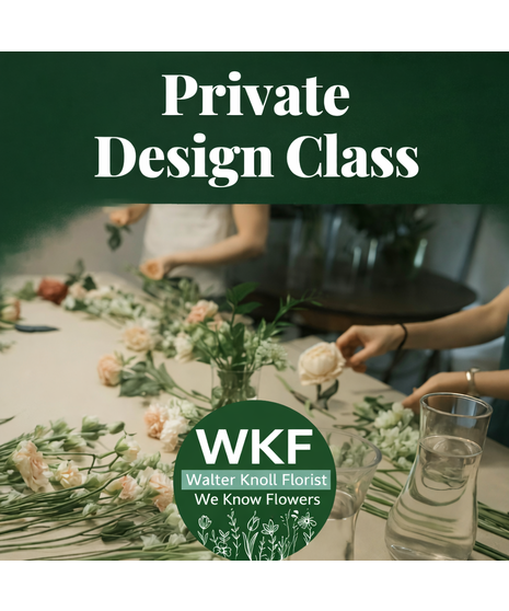 People gather around a table arranging fresh flowers with vases, tools, and stems as an instructor guides a private floral design class in a creative workshop setting.