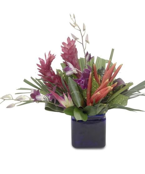 Tropical Mix: Red Torch Ginger, Purple Dendrobium Orchids in Blue Glass Cube. Deluxe includes Calla Lilies.