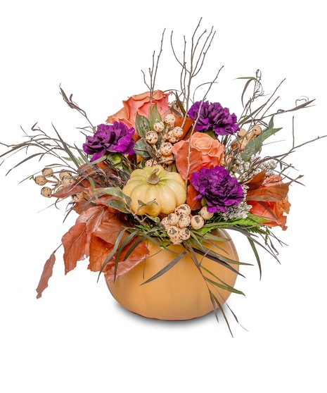 Ceramic pumpkin filled with halloween florals including purple and orange flowers with fall leaves.