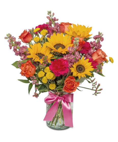 Sunny Side is a bright bouquet of sunflowers, roses, carnations, and more in a clear jar with a hot pink bow. A cheerful, uplifting gift full of color and joy.