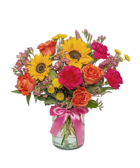 Sunny Side is a bright bouquet of sunflowers, roses, carnations, and more in a clear jar with a hot pink bow. A cheerful, uplifting gift full of color and joy.